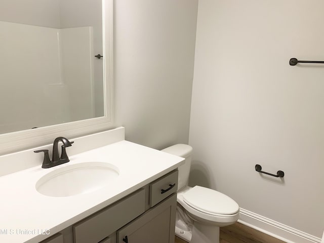 10229 Patrick Dr, Gulfport, MS 39503 - bathroom featuring vanity, toilet, baseboards, and wood finished floors