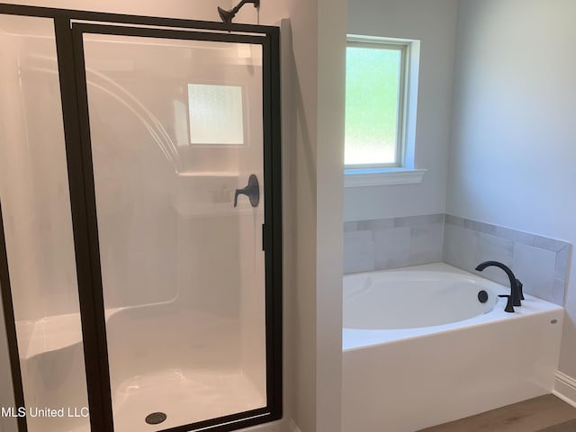 10229 Patrick Dr, Gulfport, MS 39503 - bathroom with a bath, wood finished floors, and a shower stall