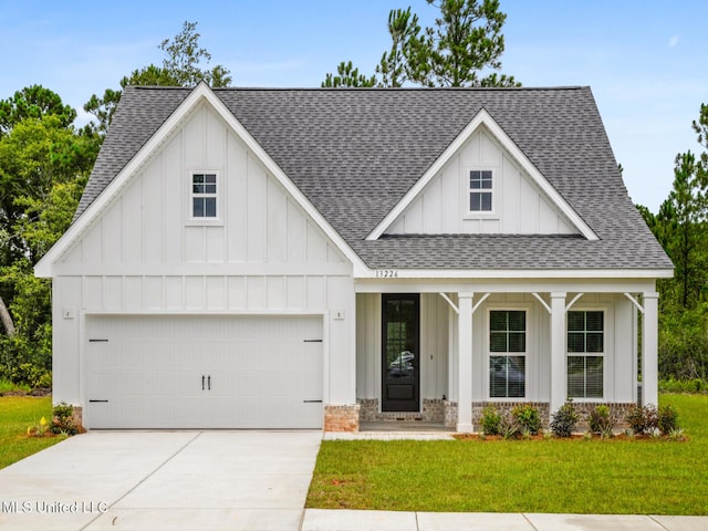 10507 Glade Cv, Gulfport, MS 39503 - modern farmhouse with a porch, board and batten siding, a front yard, and a shingled roof