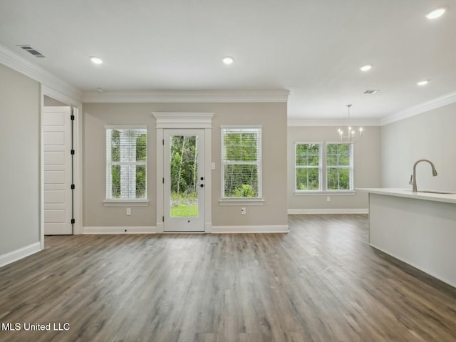 10507 Glade Cv, Gulfport, MS 39503 - unfurnished living room featuring a sink, a notable chandelier, visible vents, and wood finished floors