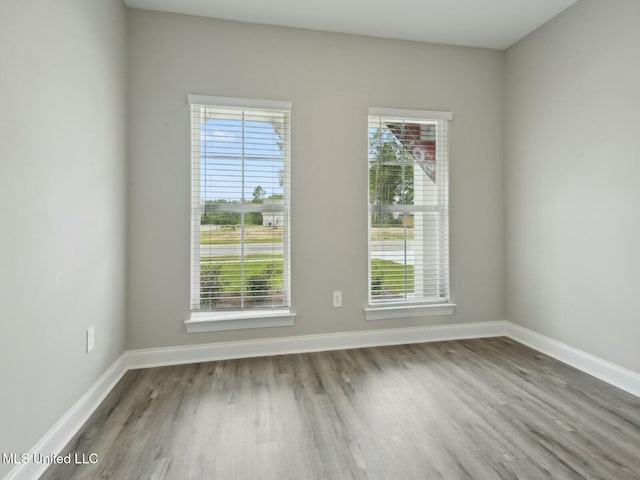 10507 Glade Cv, Gulfport, MS 39503 - unfurnished room with baseboards, wood finished floors, and plenty of natural light