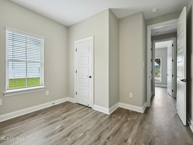 10507 Glade Cv, Gulfport, MS 39503 - unfurnished bedroom with baseboards and wood finished floors