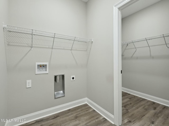 10507 Glade Cv, Gulfport, MS 39503 - laundry area featuring hookup for a washing machine, wood finished floors, laundry area, hookup for an electric dryer, and baseboards