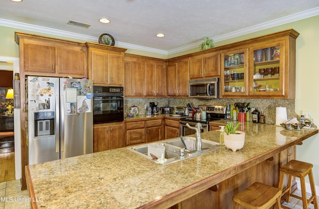102 Grand Bear Cir, Vicksburg, MS 39183 - kitchen featuring glass insert cabinets, brown cabinetry, visible vents, a peninsula, and stainless steel appliances