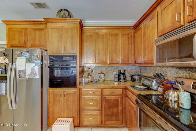 102 Grand Bear Cir, Vicksburg, MS 39183 - kitchen featuring brown cabinetry, visible vents, backsplash, light countertops, and appliances with stainless steel finishes