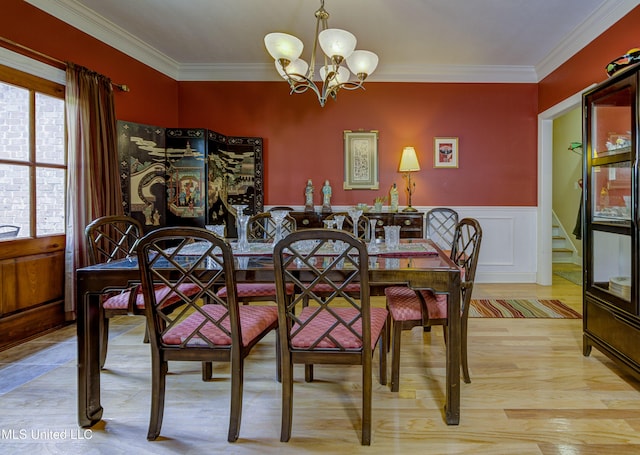 102 Grand Bear Cir, Vicksburg, MS 39183 - dining area with a notable chandelier, light wood finished floors, crown molding, and a wainscoted wall