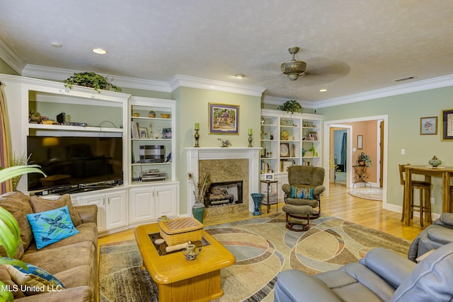 102 Grand Bear Cir, Vicksburg, MS 39183 - living area with a fireplace, crown molding, a ceiling fan, and light wood finished floors