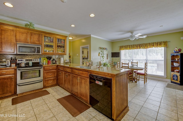 102 Grand Bear Cir, Vicksburg, MS 39183 - kitchen with light tile patterned floors, brown cabinetry, ornamental molding, a peninsula, and appliances with stainless steel finishes