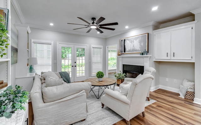 105 Lilac Ct, Madison, MS 39110 - living area with plenty of natural light, a tiled fireplace, crown molding, a ceiling fan, and french doors