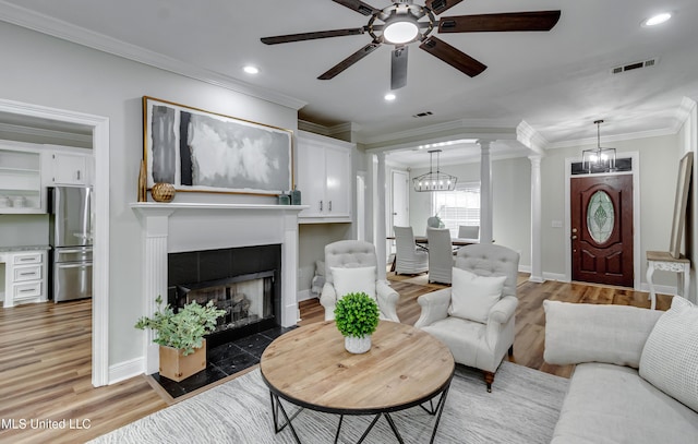 105 Lilac Ct, Madison, MS 39110 - living area featuring ceiling fan, a tile fireplace, crown molding, ornate columns, and light wood-style flooring