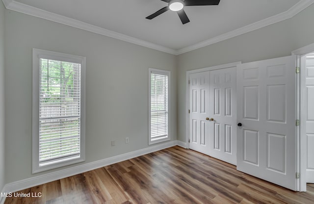105 Lilac Ct, Madison, MS 39110 - unfurnished bedroom featuring crown molding, multiple windows, wood finished floors, a closet, and ceiling fan