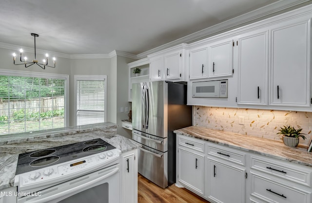 105 Lilac Ct, Madison, MS 39110 - kitchen featuring white appliances, a chandelier, white cabinets, ornamental molding, and tasteful backsplash