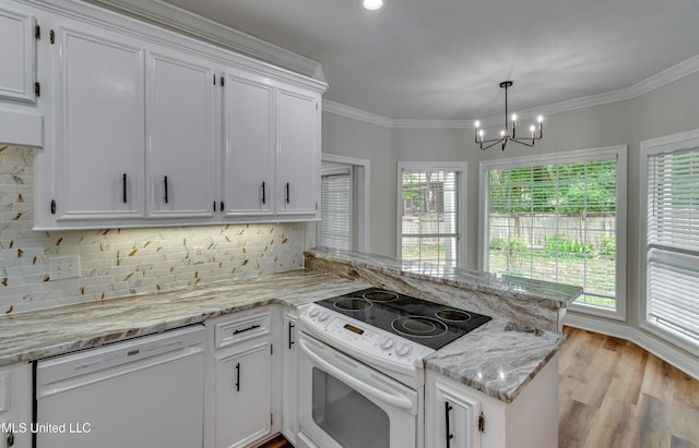 105 Lilac Ct, Madison, MS 39110 - kitchen with white appliances, a peninsula, plenty of natural light, a chandelier, and crown molding