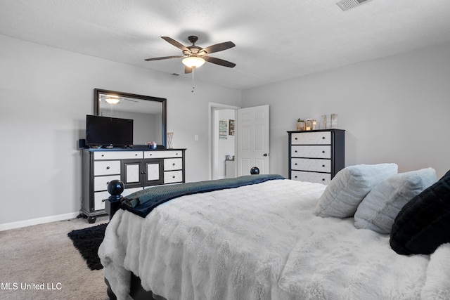 bedroom with ceiling fan, carpet floors, and a textured ceiling