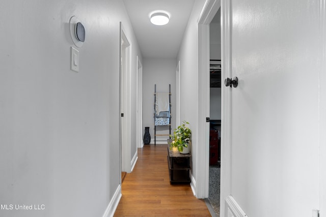 corridor with light hardwood / wood-style floors