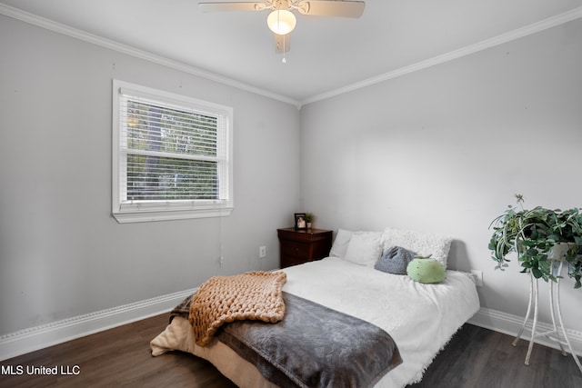 bedroom featuring ceiling fan, dark hardwood / wood-style flooring, and crown molding