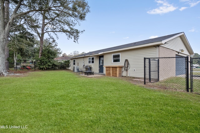 back of property with a yard and central AC