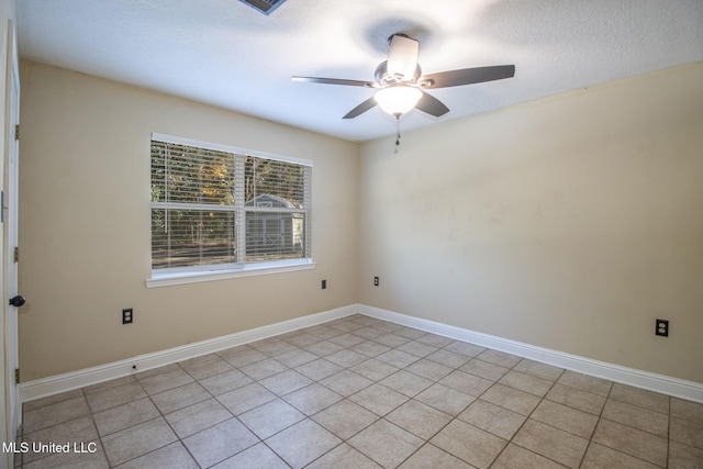 empty room featuring ceiling fan and light tile patterned floors