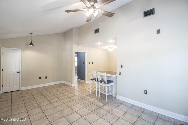 tiled empty room with vaulted ceiling and ceiling fan