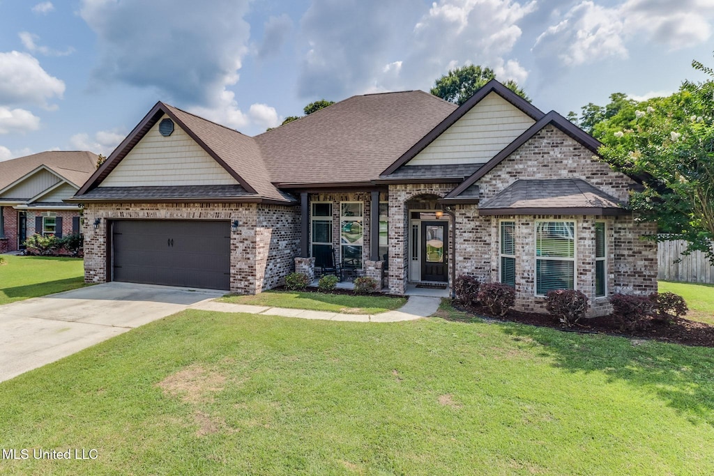 6026 Red Gate Dr, Long Beach, MS 39560 - french country home featuring brick siding, a garage, a front lawn, and driveway