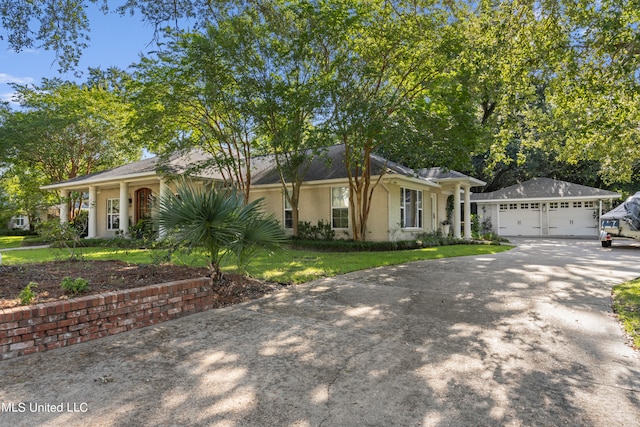 single story home with a garage and a front lawn