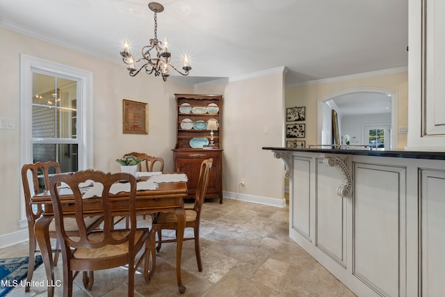 dining room with an inviting chandelier and crown molding