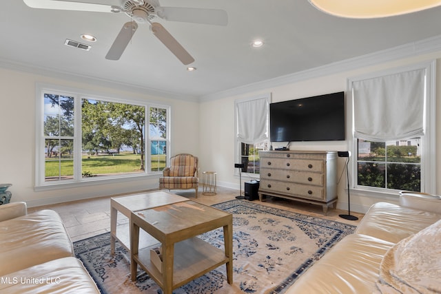 living room with crown molding, ceiling fan, and plenty of natural light