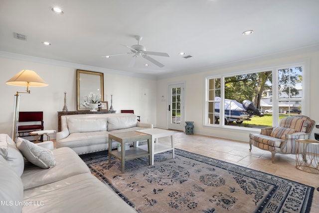 living room with ceiling fan and ornamental molding