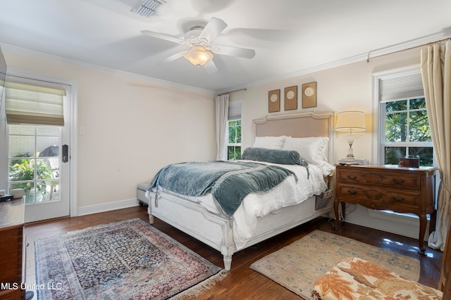 bedroom with dark hardwood / wood-style flooring, ornamental molding, and ceiling fan