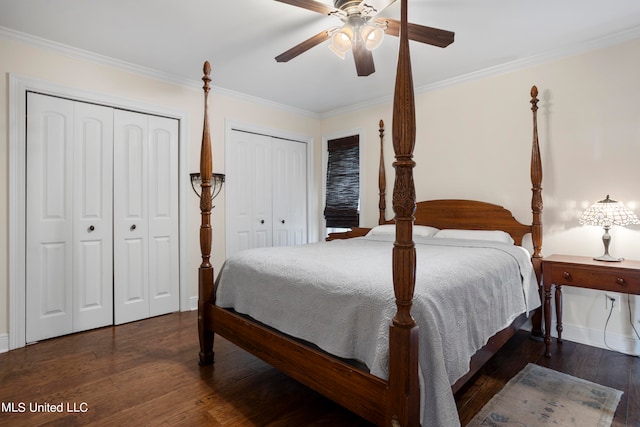 bedroom featuring ornamental molding, ceiling fan, multiple closets, and dark hardwood / wood-style flooring