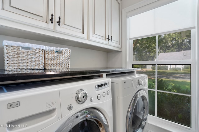 laundry room with cabinets and washing machine and dryer