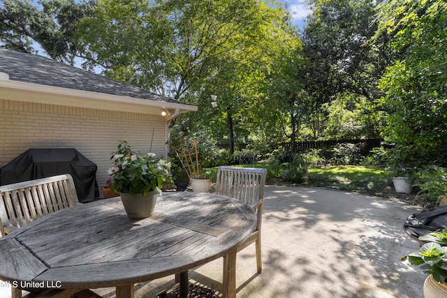 view of patio featuring a grill