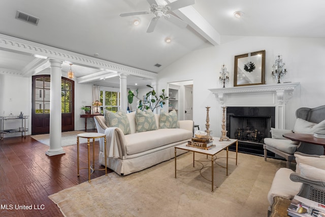 living room with wood-type flooring, vaulted ceiling with beams, decorative columns, a high end fireplace, and ceiling fan