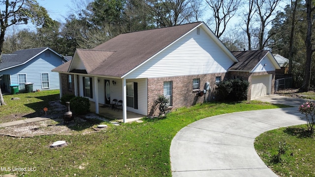 view of front of home with brick siding, concrete driveway, a front yard, roof with shingles, and a garage