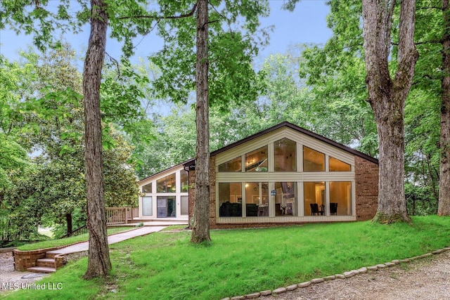 6821 Autumn Oaks Dr, Olive Branch, MS 38654 - rear view of house with a lawn and a sunroom