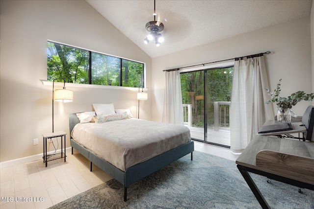 6821 Autumn Oaks Dr, Olive Branch, MS 38654 - bedroom featuring access to exterior, lofted ceiling, baseboards, a textured ceiling, and wood finished floors
