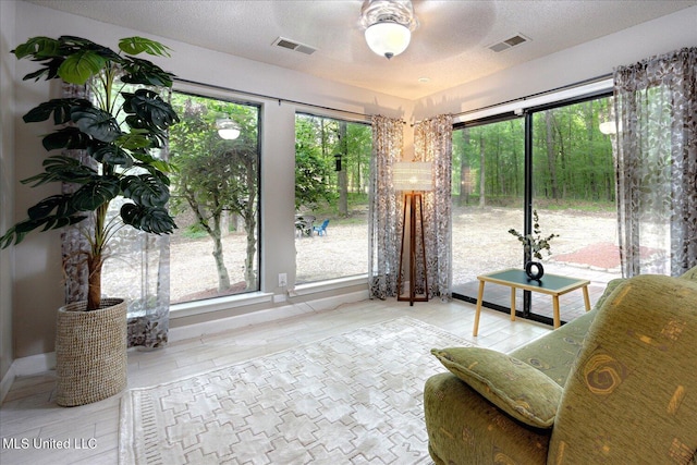 6821 Autumn Oaks Dr, Olive Branch, MS 38654 - living area featuring healthy amount of natural light, wood finished floors, and a textured ceiling
