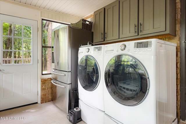 6821 Autumn Oaks Dr, Olive Branch, MS 38654 - washroom featuring washer and dryer, plenty of natural light, cabinet space, and light wood finished floors