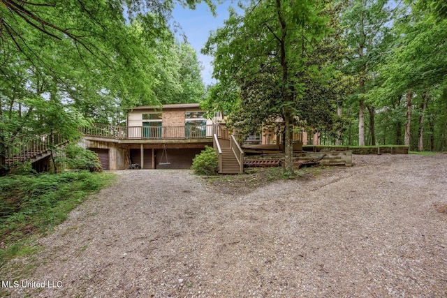 6821 Autumn Oaks Dr, Olive Branch, MS 38654 - view of front of property with stairway, a wooden deck, and gravel driveway