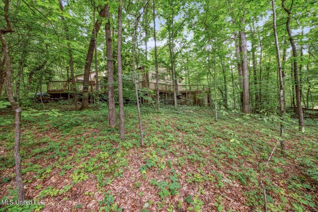 6821 Autumn Oaks Dr, Olive Branch, MS 38654 - view of yard with a deck and a wooded view