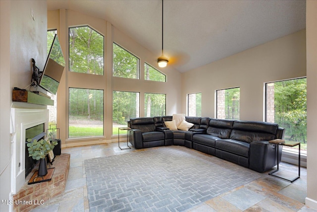 6821 Autumn Oaks Dr, Olive Branch, MS 38654 - living area with stone tile flooring, healthy amount of natural light, a fireplace, and high vaulted ceiling