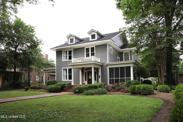 307 Grand Blvd, Greenwood, MS 38930 - view of front facade with a balcony, a sunroom, and a front yard