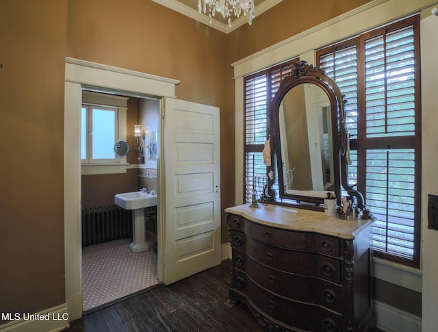307 Grand Blvd, Greenwood, MS 38930 - interior space featuring crown molding, baseboards, wood-type flooring, a chandelier, and radiator heating unit
