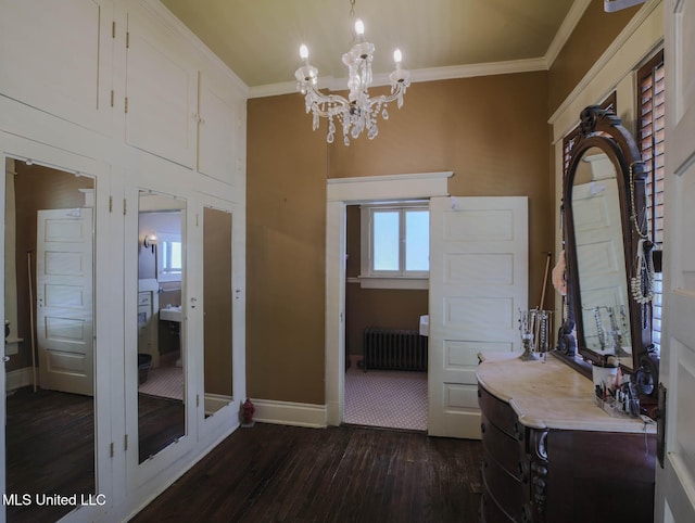 307 Grand Blvd, Greenwood, MS 38930 - bathroom with a notable chandelier, radiator heating unit, baseboards, wood finished floors, and ornamental molding
