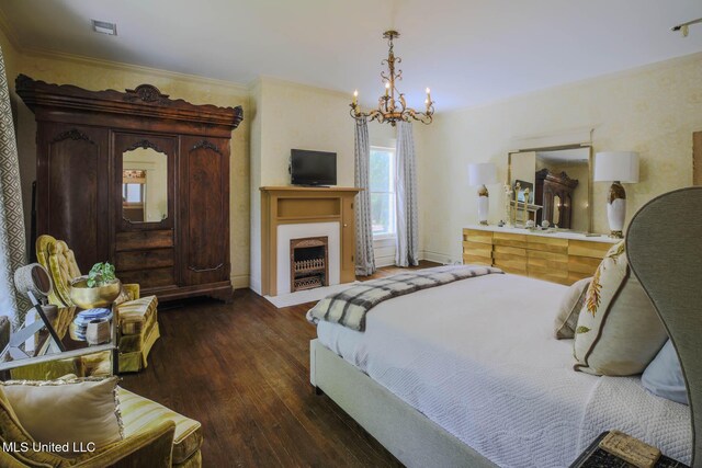 307 Grand Blvd, Greenwood, MS 38930 - bedroom with visible vents, a fireplace with flush hearth, dark wood finished floors, a chandelier, and ornamental molding