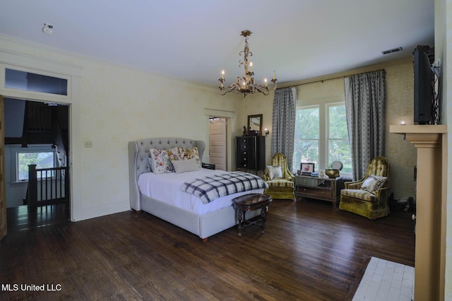 307 Grand Blvd, Greenwood, MS 38930 - bedroom featuring crown molding, a notable chandelier, baseboards, wood finished floors, and visible vents