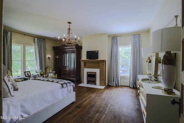 307 Grand Blvd, Greenwood, MS 38930 - bedroom with a fireplace with flush hearth, multiple windows, dark wood-style flooring, and a notable chandelier