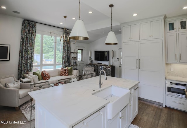 307 Grand Blvd, Greenwood, MS 38930 - kitchen featuring a sink, white cabinets, dark wood-type flooring, and open floor plan