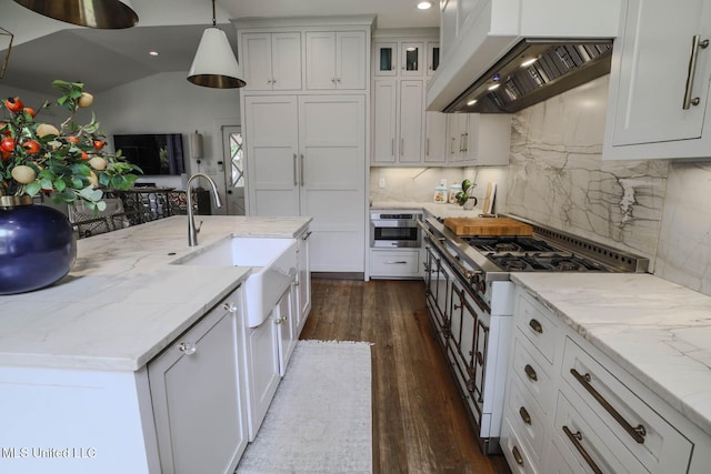 307 Grand Blvd, Greenwood, MS 38930 - kitchen with white cabinets, dark wood-style flooring, a sink, ventilation hood, and range with two ovens