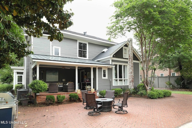 307 Grand Blvd, Greenwood, MS 38930 - rear view of property with a patio, fence, a ceiling fan, and an outdoor living space with a fire pit